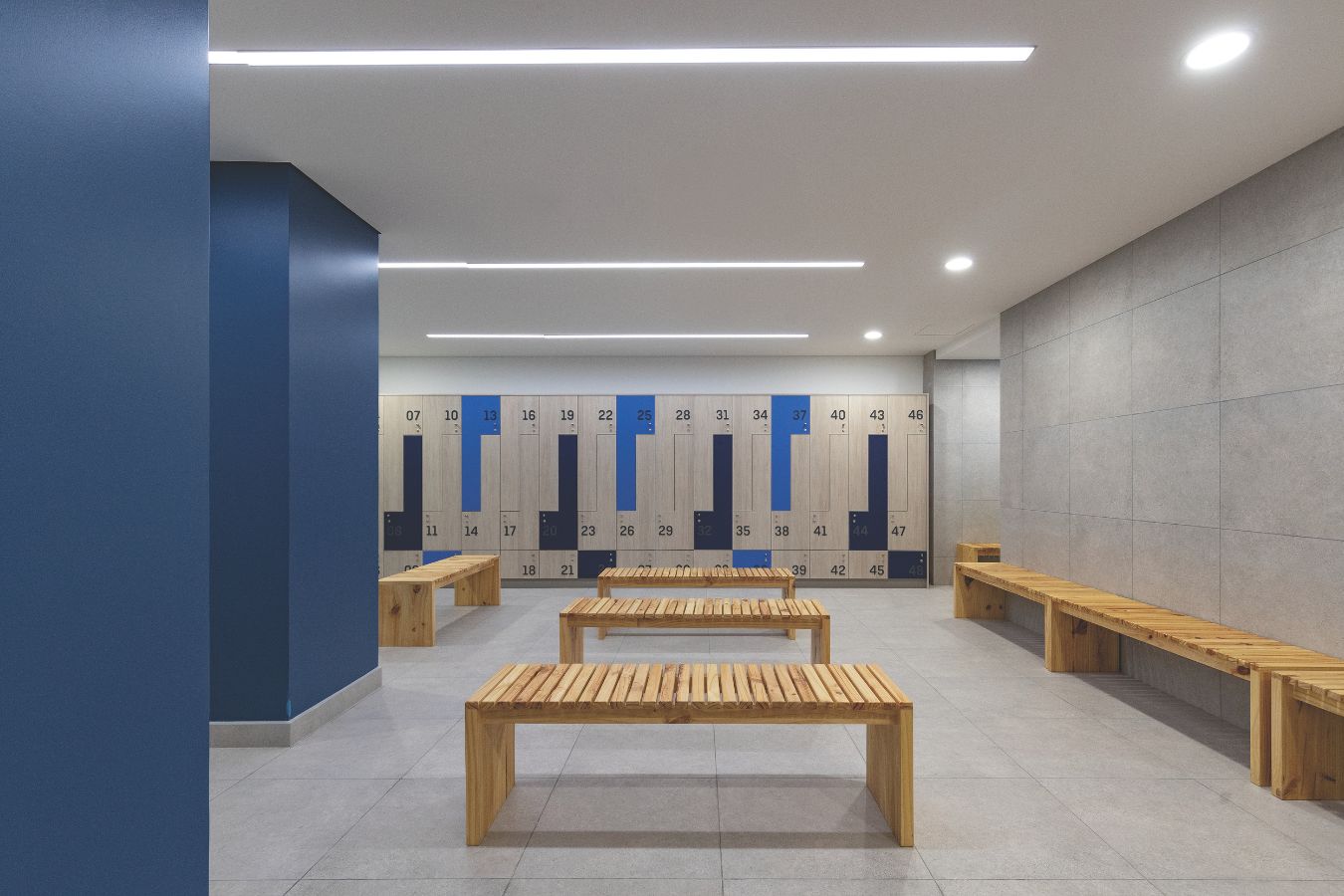 UDLA CARF - Modern athlete locker room and changing facility with blue accents - Contract Workplaces.jpg
